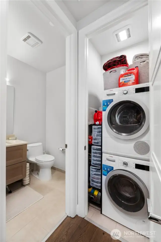 This thoughtfully designed space maximizes utility with a modern in-unit Bosch washer and dryer, tucked beside a sleek powder bath. Whether you’re rinsing off after a paddleboard session or prepping for a waterfront dinner, this layout makes everyday living easy. High-efficiency appliances, built-in storage, and smart maintenance details like regularly changed HVAC filters reflect a lifestyle that values both form and function.