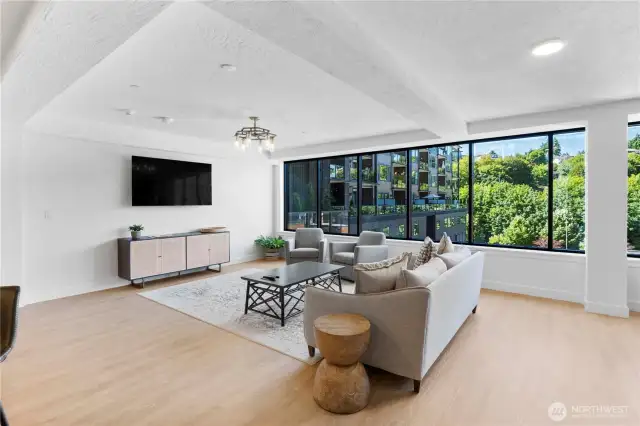 Relaxation with a view.  Framed by oversized windows and surrounded by greenery, this inviting space offers a tranquil vantage point over the Ruston neighborhood. Grab a coffee, catch up with friends, or simply take in the trees—it’s an everyday luxury you’ll appreciate more with time.
