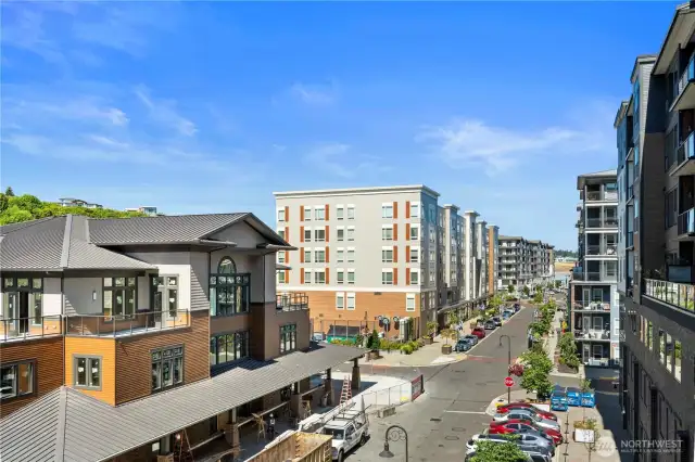 This view from the community patio captures the urban village atmosphere of Point Ruston. Just outside your door are boutique shops, coffee spots, and celebrated restaurants like WildFin American Grill, Stack 571 Burger & Whiskey Bar, and Farrelli’s Pizza. With a fully walkable lifestyle and a lively streetscape, you can enjoy dining, shopping, and entertainment without ever needing to get in your car.