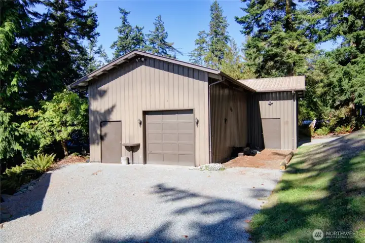 Expansive 2-bay shop with dual driveways, huge ceilings and loads of space for all your hobbies, tools, toys, and storage needs.