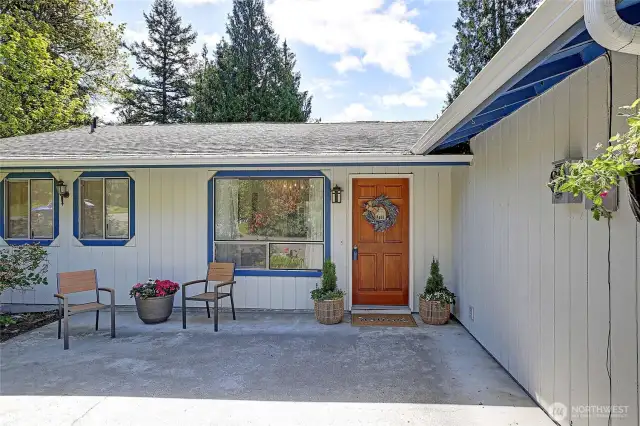 Cute patio area with various flowers & shrubs to enjoy spring through fall!