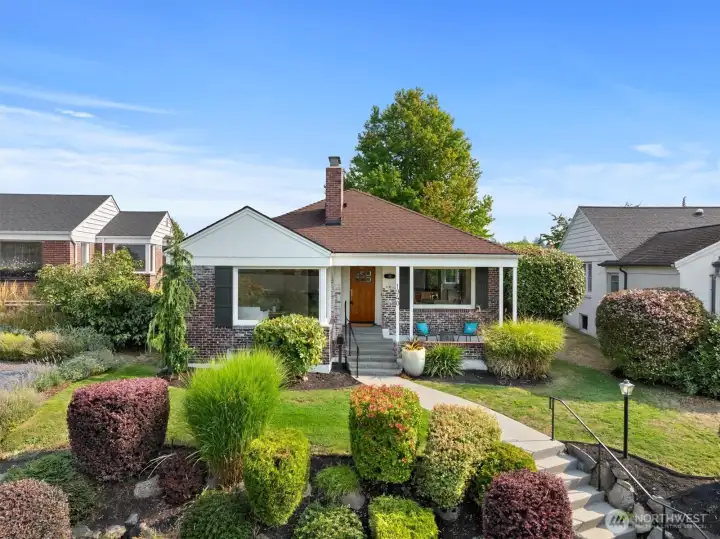 Perched gracefully above the street, this classic brick home offers timeless character blended with modern comfort.