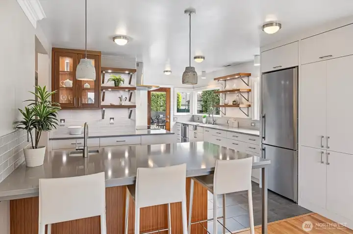 Modern kitchen with quartz counters, open wood shelving with undermount lighting , and custom cabinetry by Urban Cabinets (Woodinville).