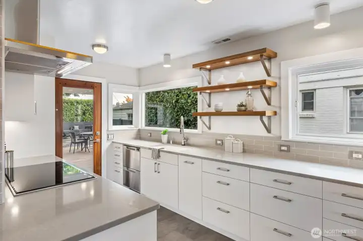 Wolf wall ovens, Fisher & Paykel two drawer dishwasher, Liebherr refrigerator, and induction cooktop.