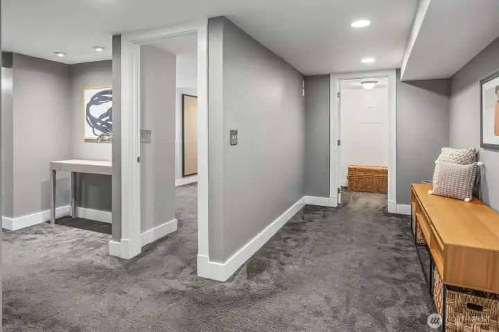 Flexible lower-level bonus area with recessed lighting, fresh finishes, and an additional closet for seasonal storage—an ideal spot for a reading nook, play area, or extra workspace while connecting bedrooms, bath, and family room.
