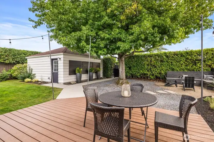 Just to the left of the patio set is a platform made to fit a cantilever umbrella so as not to take up deck space.