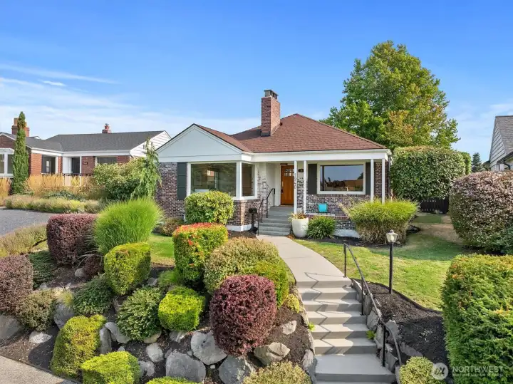 Beautiful mature landscaping, newer concrete steps and custom handrails.