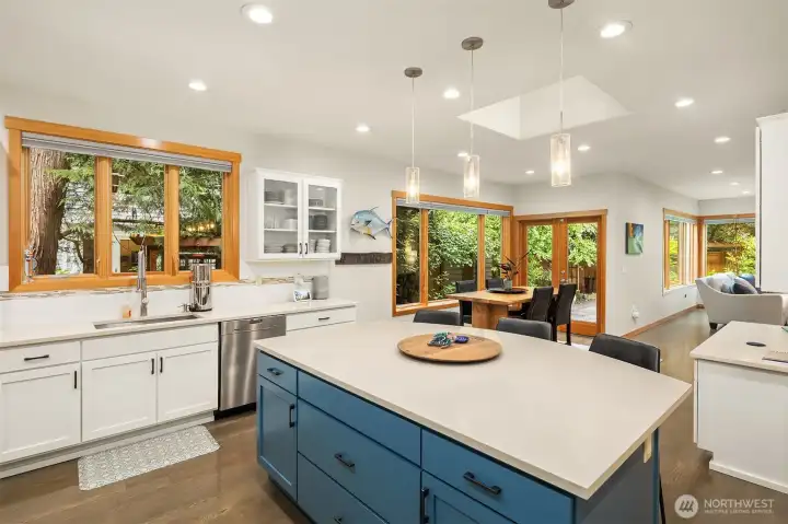 Adjacent is a large eating nook and planning desk, with great sightlines to the family room and outdoor space.