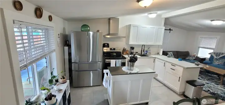 Open concept with kitchen, living and dining area.