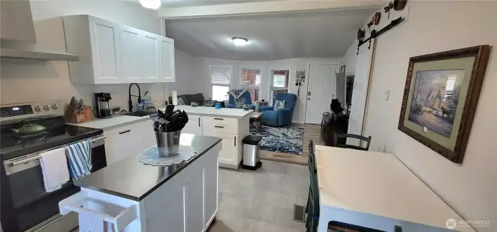 Open concept with kitchen, living and dining area.