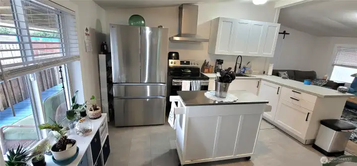 Open concept with kitchen, living and dining area.