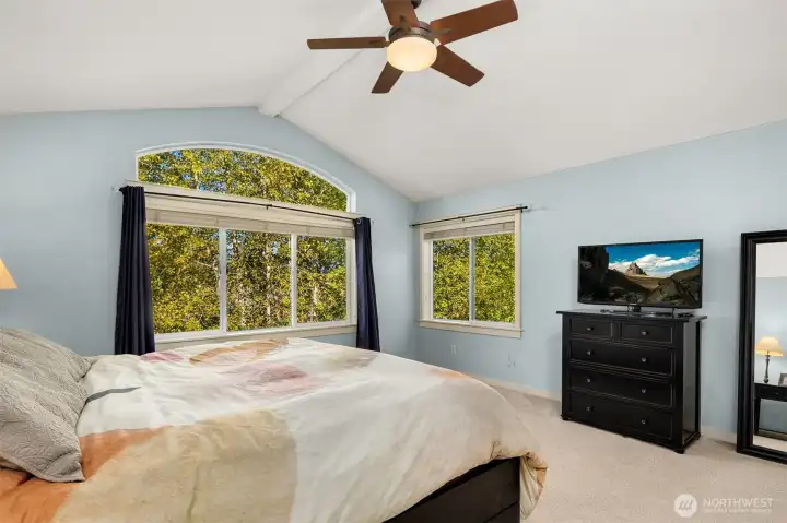 Primary bedroom with vaulted ceiling