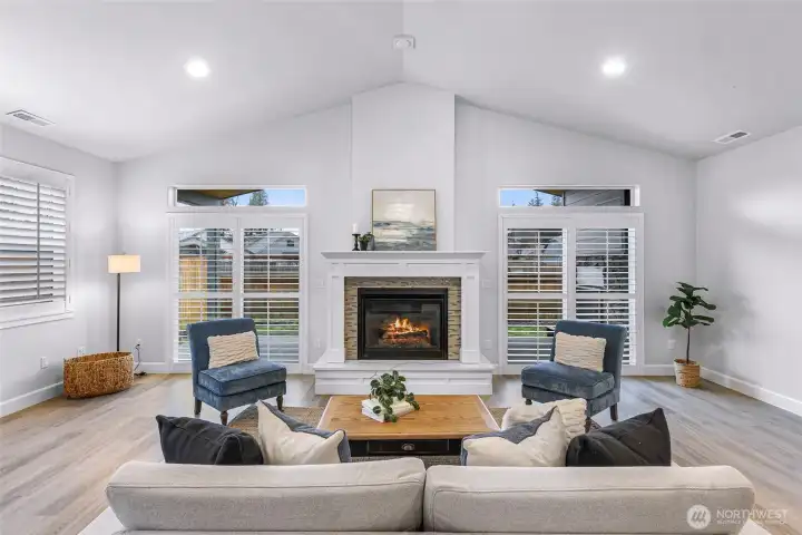 Gas fireplace is flanked by 2 siding door to access covered patio