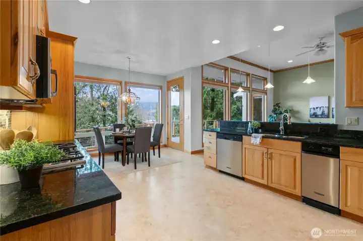 Kitchen with granite countertops, wood cabinetry, stainless steel appliances, and recessed lighting