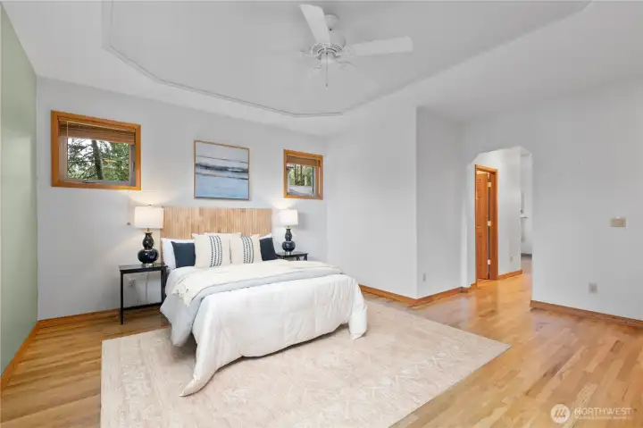 Generous primary bedroom with ensuite bath, walk-in closet and back deck access.