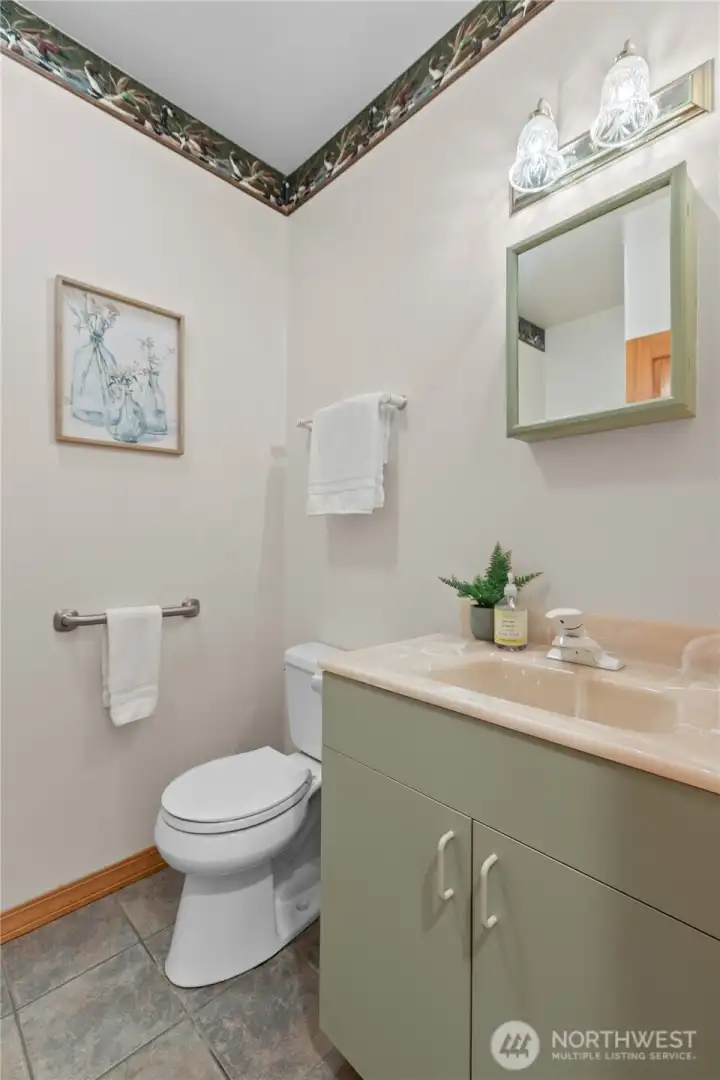 Three-quarter guest bathroom with single vanity and tile flooring