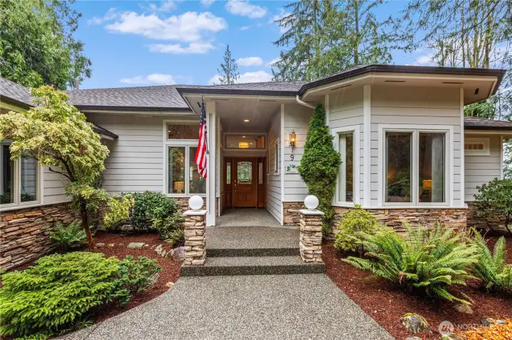 The attractive exterior is loaded with curb appeal thanks to a covered entry and mature landscaping