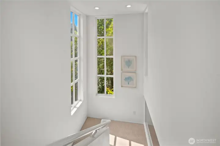 Landing between the floors with more amazing windows. Landing between the floors with more amazing windows.