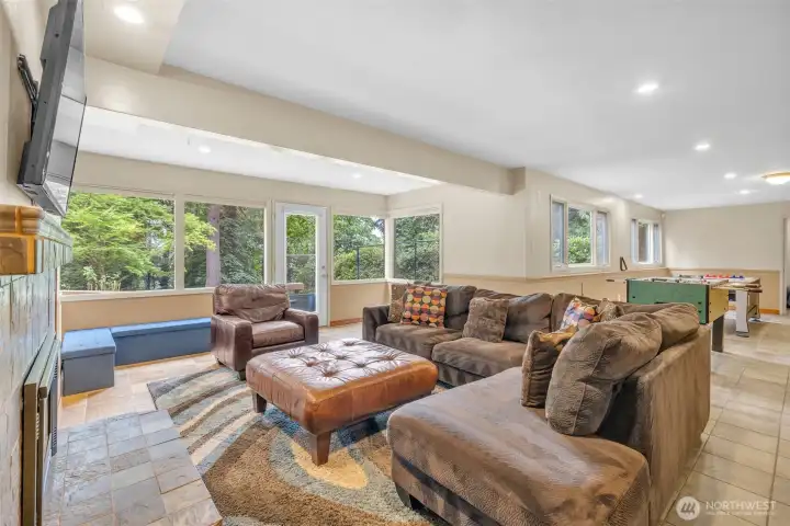 Living room w/ gas fireplace (lower floor). Door to patio & backyard.