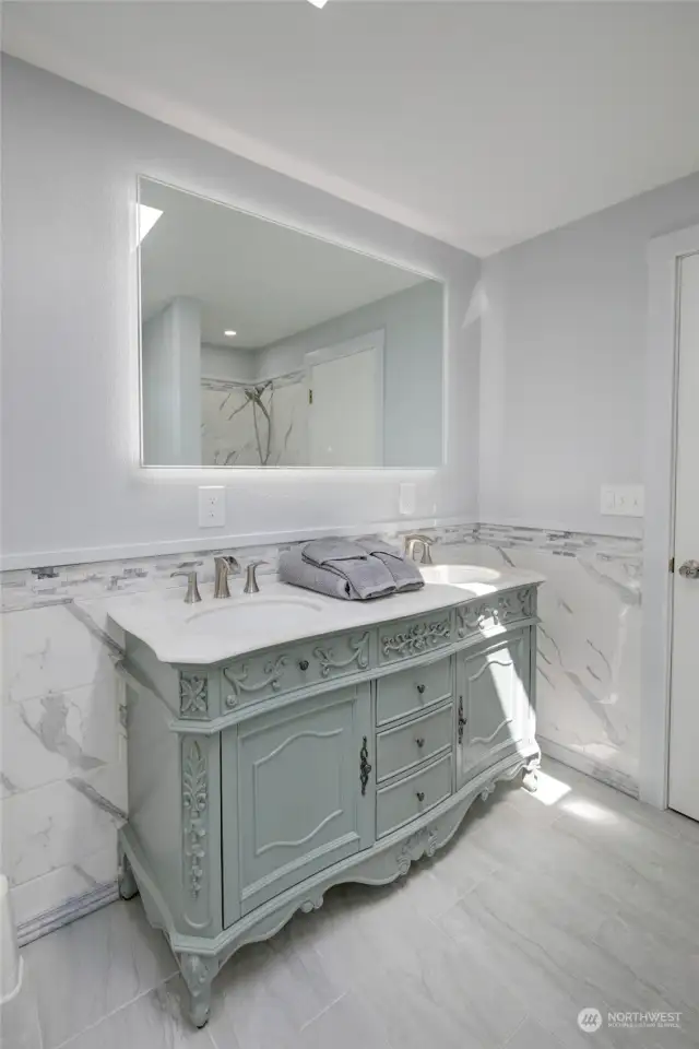 Primary bathroom vanity with LED backlit mirror