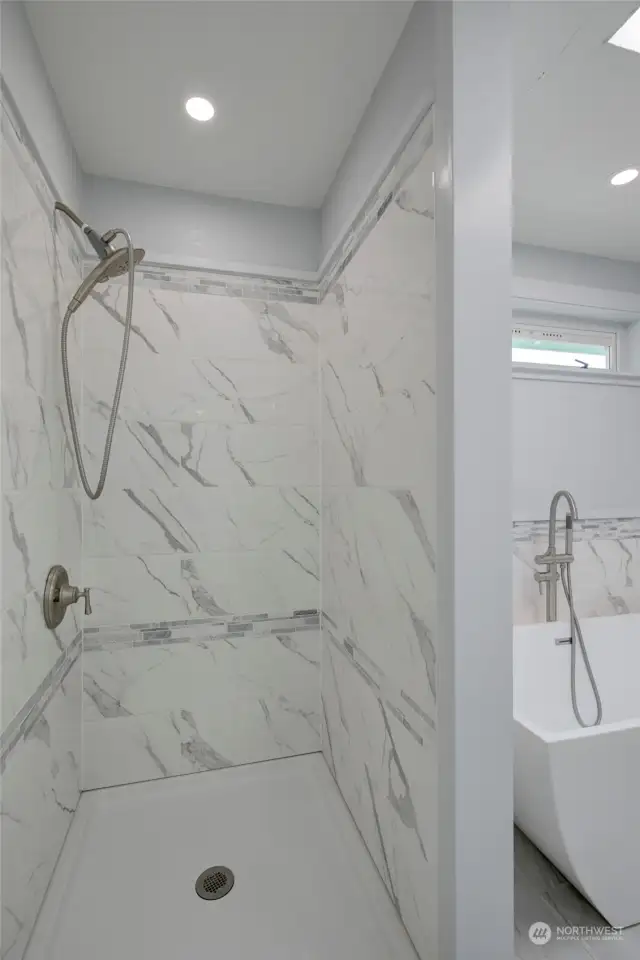 Primary bathroom marble tile shower