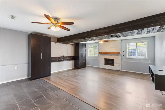 Huge bonus room with fireplace, built-in cabinets, ceiling fan and access to a patio and the backyard.