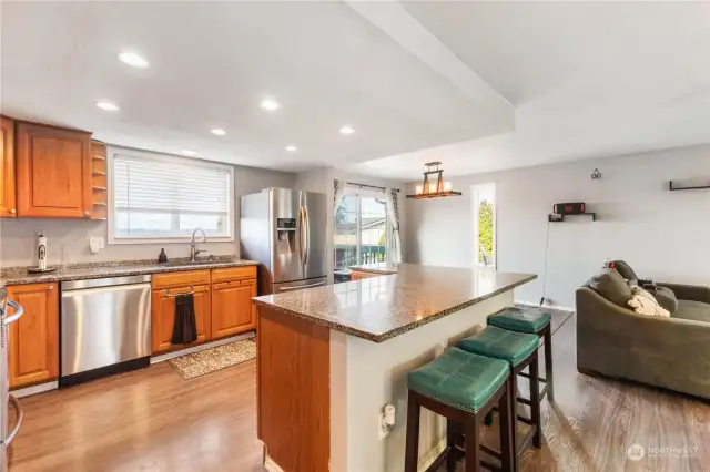 Spacious kitchen with granite counters, stainless appliances, breakfast bar and plenty of cabinet and counter space.