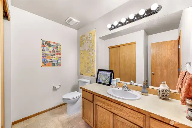 The generous half bath on the main level offers extra storage for convenience.