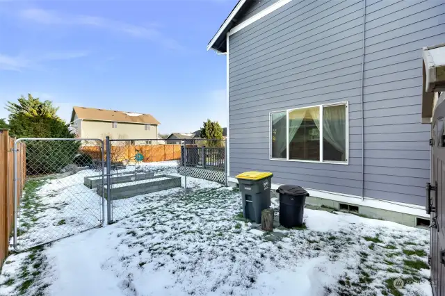 On the side of the home, there is a dedicated dog run, providing a secure space for pets.