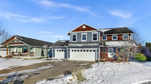 A stunning view of this beautiful NW craftsman home, showcasing its charming design and spacious 3 car garage.