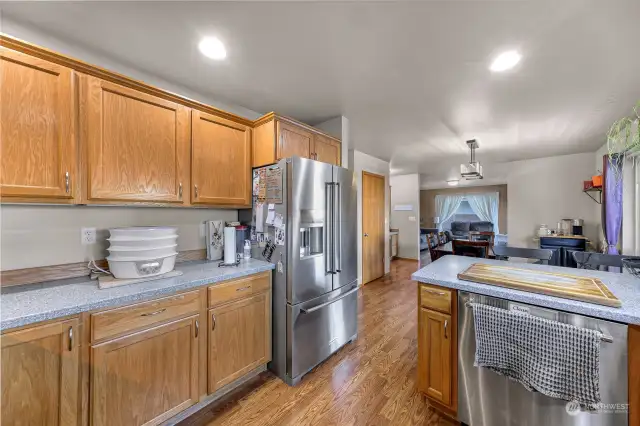 This view of the kitchen highlights open concept connecting to the dining room and family room.