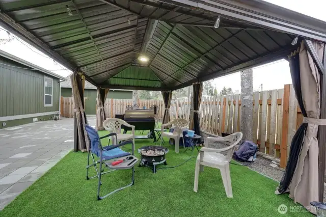 Great fully fenced low maintenance yard with patio pavers, gazebo, firepit, barbeque area.