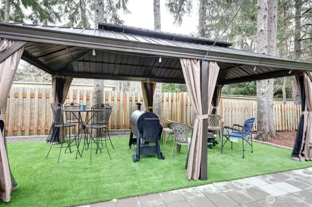 Great fully fenced low maintenance yard with patio pavers, gazebo, firepit, barbeque area.