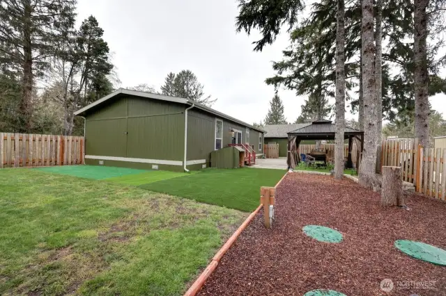 Great fully fenced low maintenance yard with patio pavers, gazebo, firepit, barbeque area.