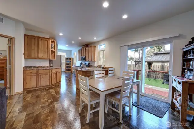 Dining room, kitchen and sliding door to the fully fenced back yard.