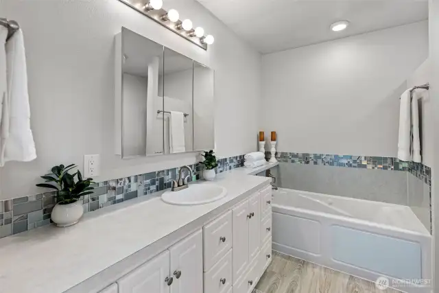 Located on the main floor for ease and comfort, the primary ensuite bath offers a spa-like escape with calming tones, clean lines, and a spacious walk-in shower—your personal retreat at the end of the day.