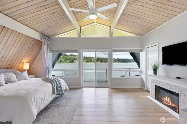 This upper-level second primary suite is a showstopper, featuring vaulted wood ceilings, a private balcony, and sweeping lake views that stretch out for miles. Whether for guests, multi-gen living, or your personal retreat, it offers the perfect blend of comfort and drama.