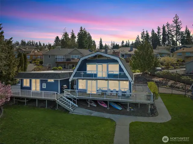 Evenings glow a little brighter here. The expansive lake-facing deck and glowing windows invite you to unwind, entertain, and live life at the water’s edge—all with a front-row seat to lake sunsets.