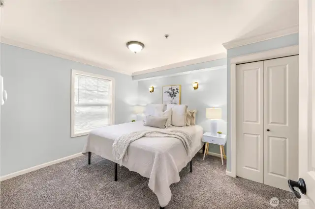 King size bed highlights the spacious and bright primary bedroom