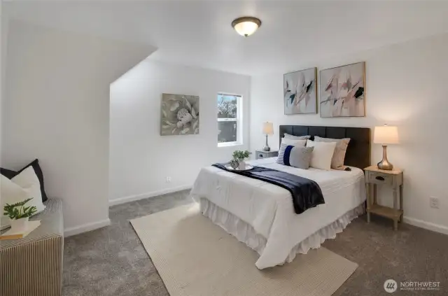 Find a perfect retreat in this spacious primary bedroom that offers beautiful natural light through the skylight and window.