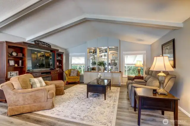Walk into the Entry that opens to the Living Room enhanced with Vaulted Ceilings & Built-In Entertainment Center!