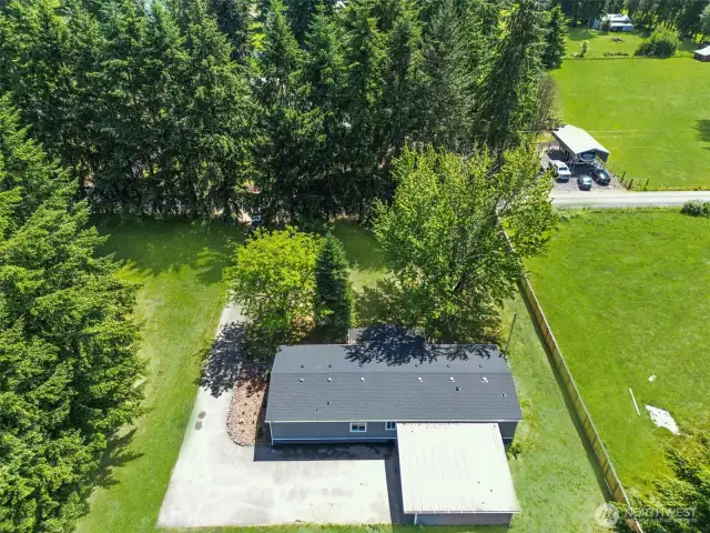 323 Goodrich Road. Nice, clean driveway with carport, small work shed, and additional outbuildings