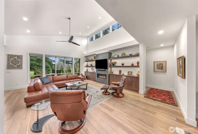 Viewsa of the golf course during the day, and the fireplace at night make this a magical living space.  The clerestory windows have automatic shades that can be closed if it becomes too bright!  The primary bedroom is accessed from the hall to the right.