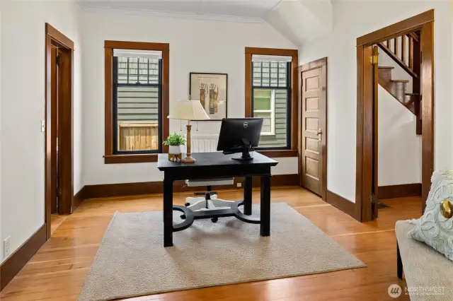 This room is at the heart of the main floor. It can be used as an office or a main floor bedroom. There is a 3/4 bath accessible via the door to the left.