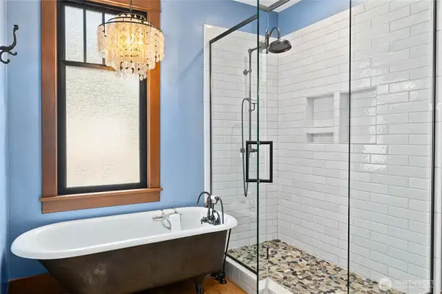 A beautifully tiled shower with a glass door complements the space, while Mason Hill Collection plumbing fixtures throughout the bathroom add a touch of artisan quality and timeless sophistication.