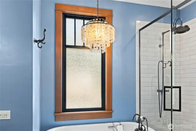 Topping it all off is a striking chandelier, bringing elegance and a touch of whimsy to this one-of-a-kind bath retreat.
