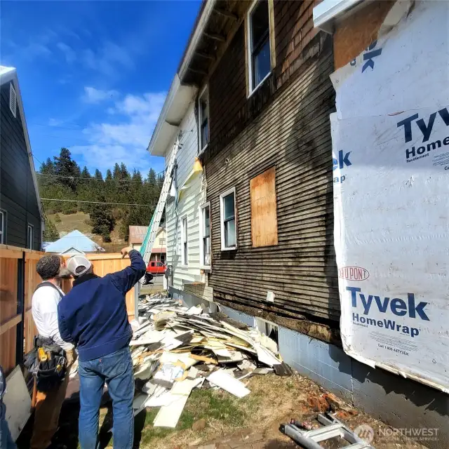 Restoration process: the contractors tore off three layers of newer siding before finding a portion of the siding authentic to the house as the fourth layer.