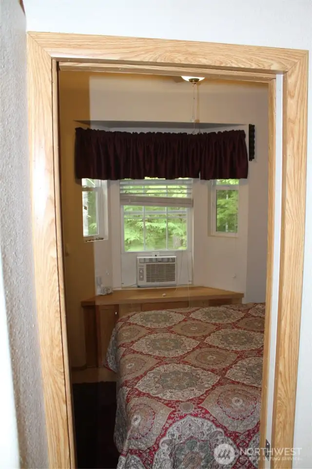 As you enter the bedroom, air conditioning in the window.