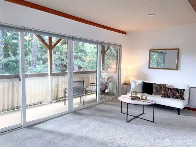 The living room has a sliding glass door to the covered deck.  New carpet too!