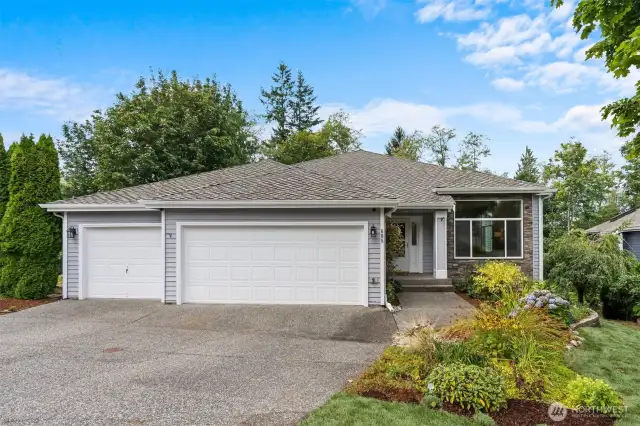 Meticulously maintained landscaping adds to the home's curb appeal. A beautiful side yard with mature plants and a low-maintenance design.